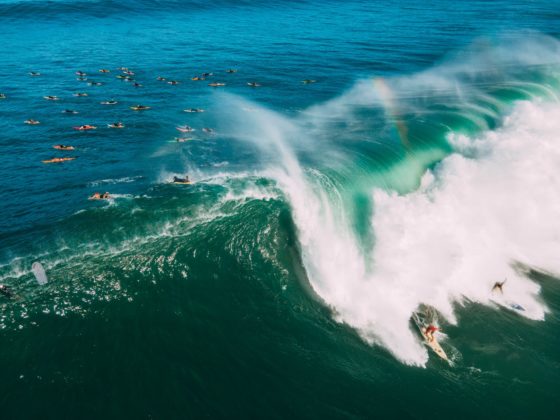 aerial view of people surfing on big waves