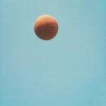 brown basketball on blue sky