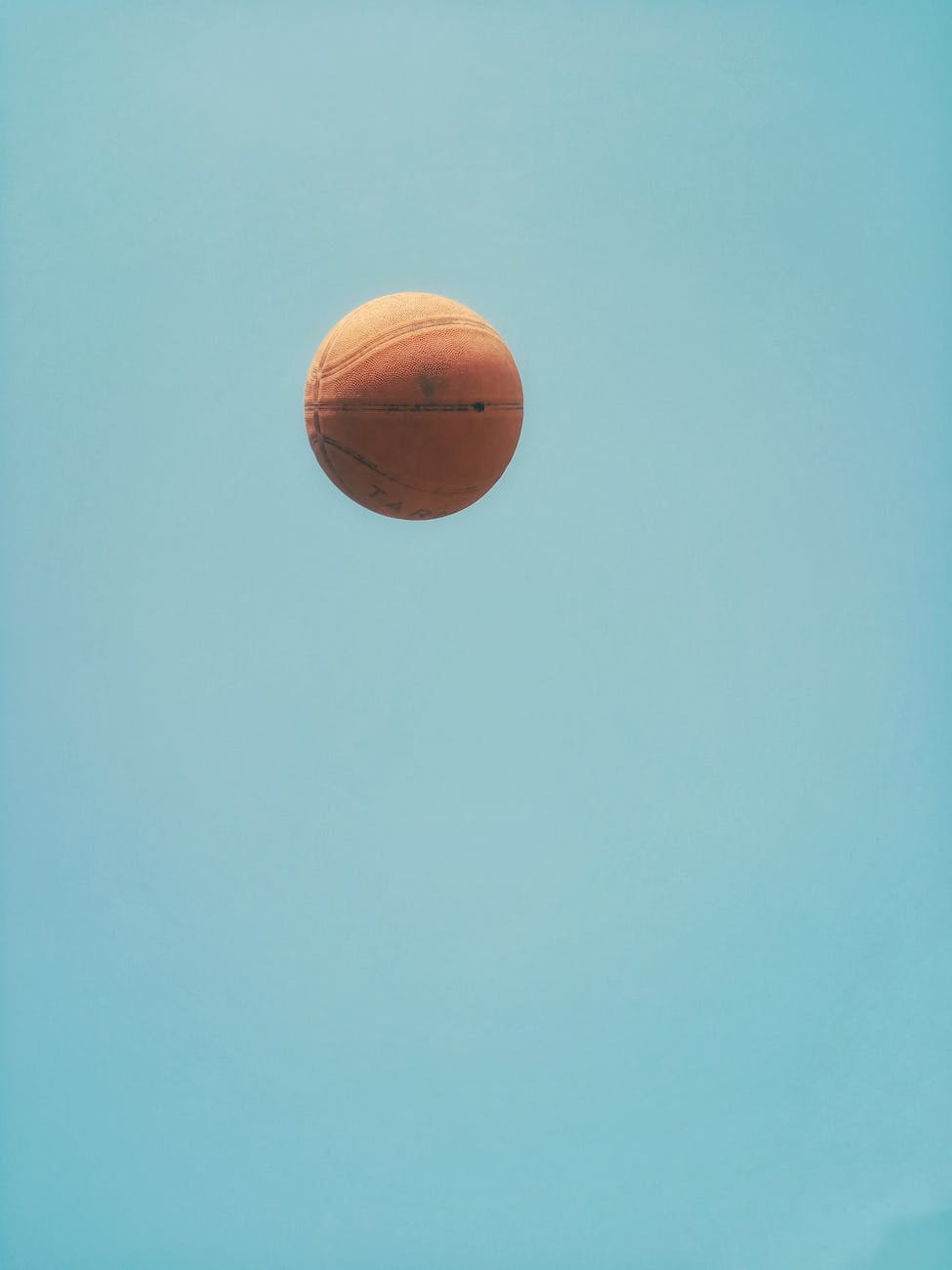 brown basketball on blue sky