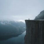 two people on mountain cliff