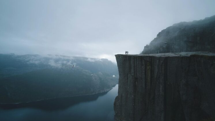 two people on mountain cliff