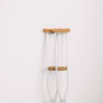 crutches against light white wall
