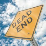 yellow dead end sign during day time