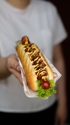 woman holding an american hot dog
