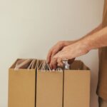 a person looking through a cardboard file organizer