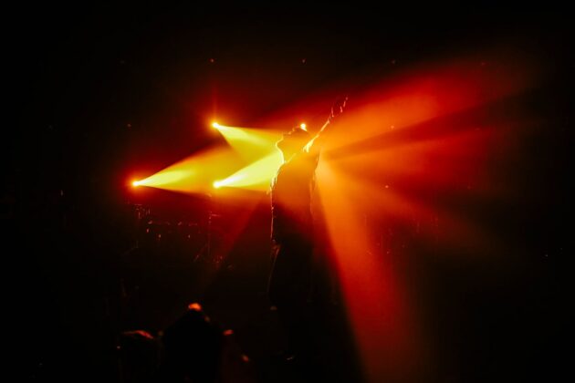 silhouette of man with his arm raised